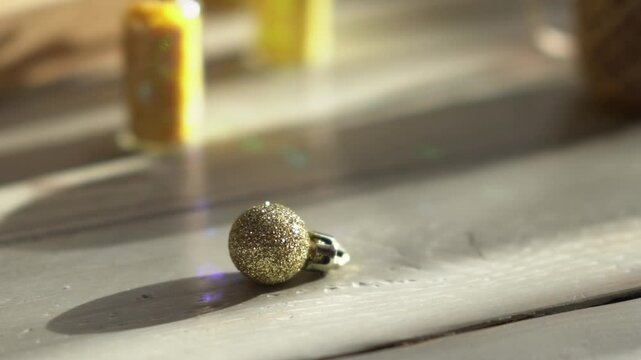 Holiday decor. Packing holiday gifts. Gift boxes, silver bow and Christmas gold balls against the backdrop of the Christmas tree and golden bokeh