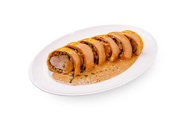 Delicious beef wellington with creamy sauce prepared in a cozy kitchen