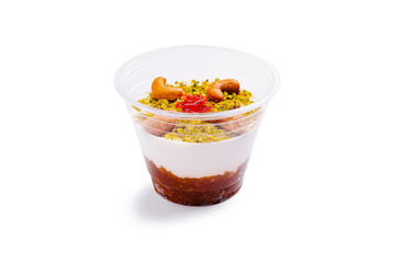 Delicious dessert cup with yogurt, syrup, and nuts ready to be enjoyed