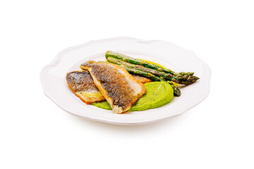 Delicious pan-seared fish with asparagus and green puree served on a plate