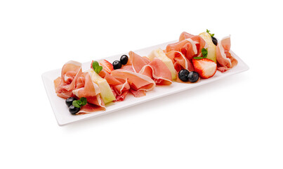 Delicious charcuterie platter featuring prosciutto with berries and mint
