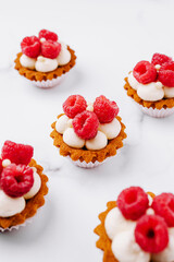 Delightful raspberry mini tarts displayed on a marble surface