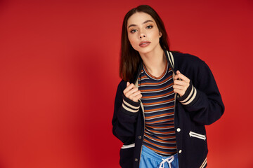 Vibrant fashion and youthful elegance shine in a bold red backdrop
