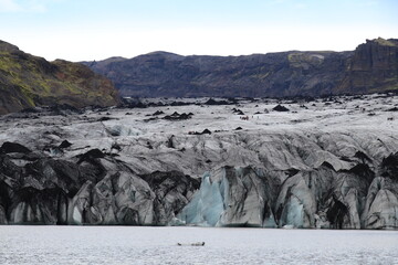 panoramic view of the glacier lagoon, the volcanic mountains and the Solheimajökull and...