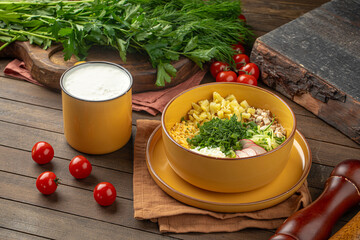 Cold summer russian soup okroshka with kefir on wooden decorated background