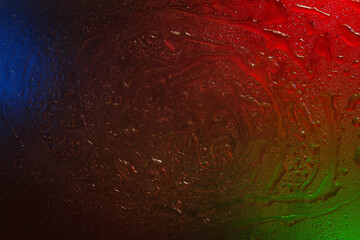 Wet glass. Drops on glass. Abstract dark texture. Light spots.
