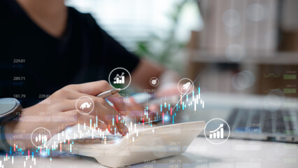 Close-up hand using calculator with financial chart and investment icons overlay. Concept of...