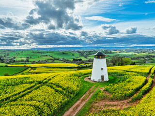 Rapeseed fields and Farms over Devon Windmill from a drone, Torquay, Devon, England