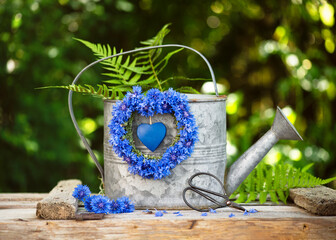 Summer flower arrangement with handmade wreath made of fresh deep blue cornflowers (Centaurea...