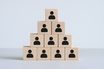 Organizational Pyramid: A pyramid of wooden blocks, each adorned with a symbolic icon, stands as a visual representation of organizational structure and team hierarchy, on a neutral surface.