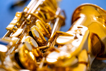 A saxophone, a classical woodwind instrument, is shown with a golden, brass-coloured, shiny surface...