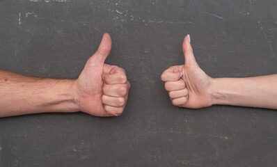 Male and female hands showing approval signs, expressing agreement, support and consent. Two hands...