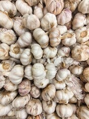 Pile of Fresh Garlic Bulbs Displayed at a Market for Cooking Ingredients