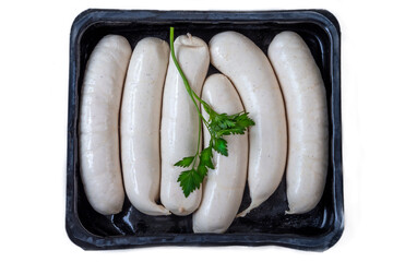 Sausages in a tray with fresh herbs