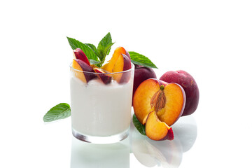 Whole and cut nectarines with yogurt on clean background