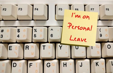 Computer keyboard with note written I'm On Personal Leave - Means business leave - Employee take a leave of absence - Worker take time off for personal or private reasons
