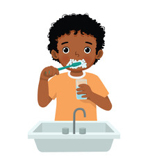 Little African boy brushing teeth with tooth brush for dental care