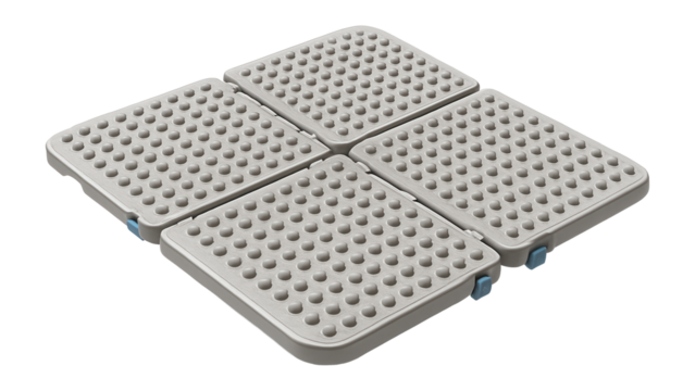A versatile anti-slip mat with modular design, allowing customizable fit for varied shower sizes in a public swimming pool.