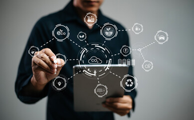 Man using futuristic interface with smart tech and mobile to manage ESG, clean energy, and sustainability data.