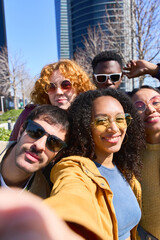 Group of young friends taking a selfie in the city