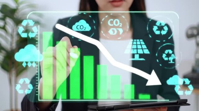 Young Woman Analyzing Carbon Reduction Bar Chart with Green Elements and Recycling Icons in Bright Office Environment