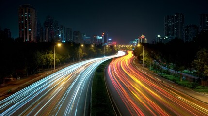 Fototapeta premium Busy highway at night with long exposure light trails from vehicles, capturing the dynamic energy of urban transportation and movement
