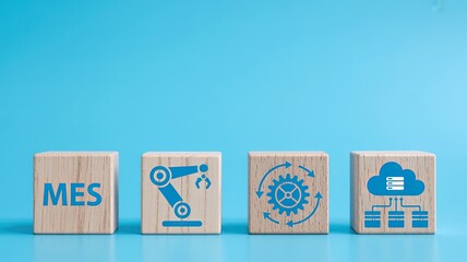 Wooden blocks with mes manufacturing automation robotics cloud computing and process flow icons on a blue background