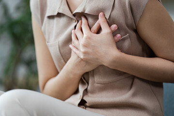 Chest Pain and Discomfort. A person holding their chest, indicating potential health concerns.