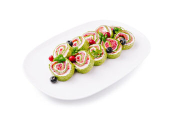 Colorful vegetable rolls served on a white plate with fresh ingredients