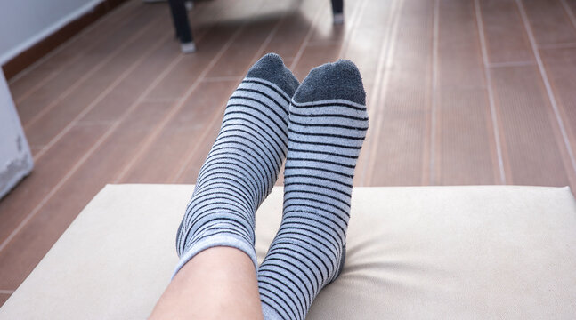 Gray socks with black stripes on boys feet - Powered by Adobe