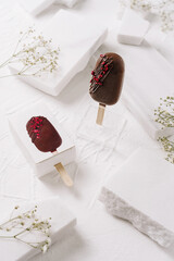 Delicious chocolate ice cream popsicles on a minimalist white background