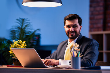 Businessman drafting email of typing at desk, Indian executive focused on digital communication