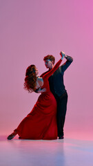 A graceful pair, a man and woman, perform an expressive Argentine tango dance routine. The idea of...