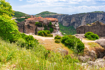 Medieval Greek monastery built on rocky cliff surrounded by mountains in Meteora Greece