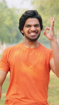 Vertical Sot of Encouraging Young Indian Man 