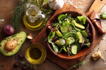 Fresh green salad with avocado and olive oil.