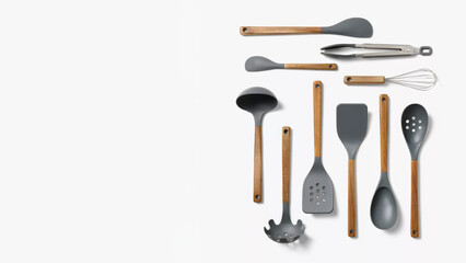 Completed kitchen utensil set arranged neatly on a white surface with wooden handles.