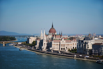 Fototapeta premium View landscape and cityscape of Budapest old town city and Hungarian Parliament with tour cruises in Danube Delta river and Budapest Chain Bridge in Budapest, Hungary