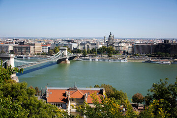 Fototapeta premium View landscape and cityscape of Budapest old town city and Hungarian Parliament with tour cruises in Danube Delta river and Budapest Chain Bridge in Budapest, Hungary