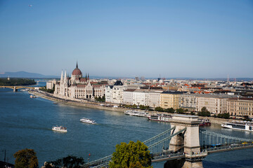 Naklejka premium View landscape and cityscape of Budapest old town city and Hungarian Parliament with tour cruises in Danube Delta river and Budapest Chain Bridge in Budapest, Hungary