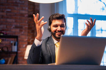 Indian executive with headset busy in call center, symbolizing communication and customer service