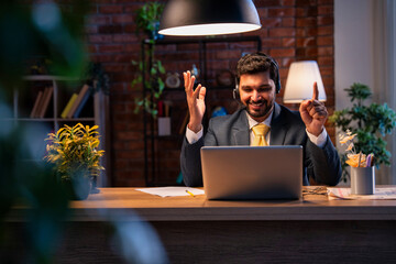 Indian executive with headset busy in call center, symbolizing communication and customer service