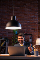 Indian executive with headset busy in call center, symbolizing communication and customer service