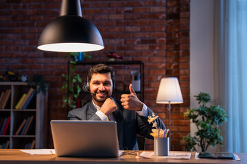 Indian executive with headset busy in call center, symbolizing communication and customer service
