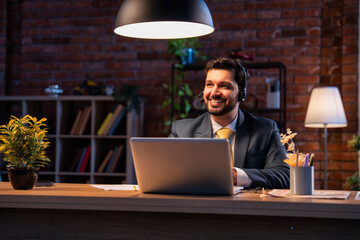 Indian executive with headset busy in call center, symbolizing communication and customer service