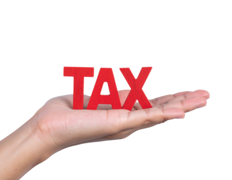 A hand holding bold red letters spelling "TAX" against a black background, symbolizing financial obligations or taxation concepts.