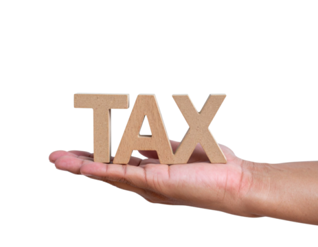 A human hand is holding large wooden letters spelling the word "TAX.