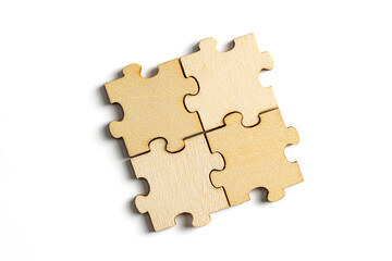 Wooden jigsaw puzzle pieces isolated on white background.