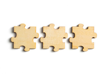 wooden jigsaw puzzle pieces isolated on white background.