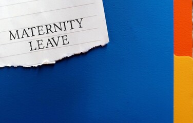 Office folder with torn note written Maternity Leave - period in which female employees allowed to absent from work before and after she gives birth - to take care of newborn child